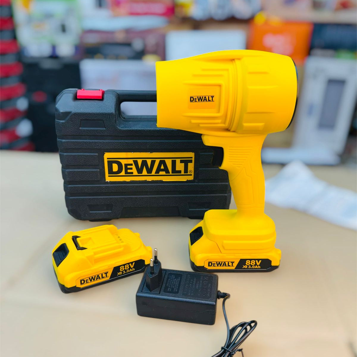 DeWalt power drill set with case, battery, and charger on a light surface.